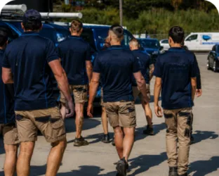 Plumbers walking to their service vans on a Kellyville job